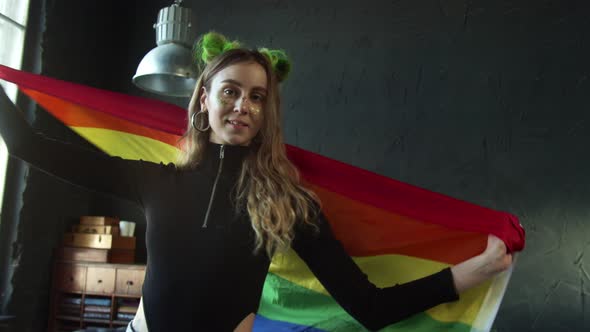 Beautiful Girl Hanging Out in the Studio Waving LGBT Pride Flag alt
