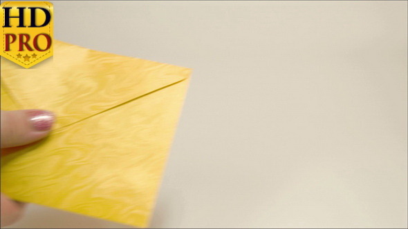 A Yellow Small Envelope Given to a Lady Hand