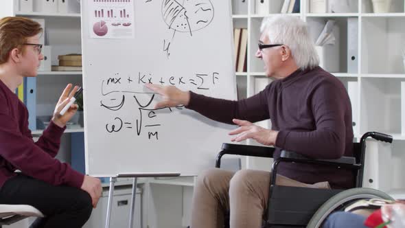 Disabled Teacher Explaining Equation to Student alt