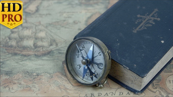 The Compass Beside a Blue Book