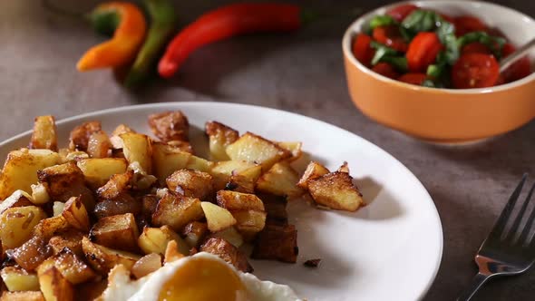 Putting Eggs near Fries with small pieces of fat pork meat, onion and garlic