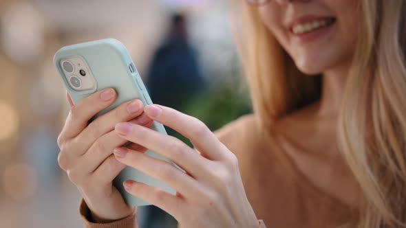 Closeup Side View of Unrecognizable Girl with Glasses Holding Phone Female Hands Swipe on Smartphone alt