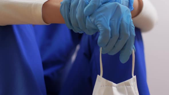 Tired Doctor or Nurse with Medical Face Mask alt