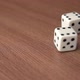 Throwing two white plastic gaming dices on a wooden surface. - VideoHive Item for Sale