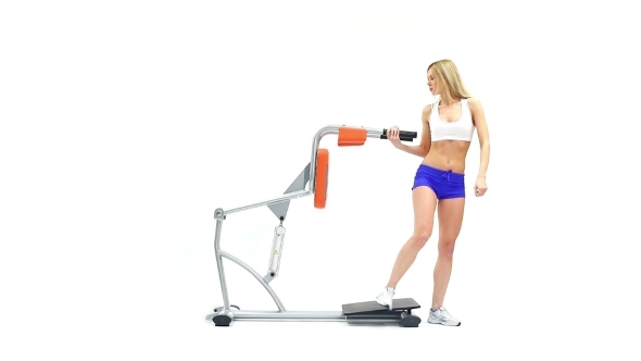 Athletic Woman Shows Exercise On Trainer