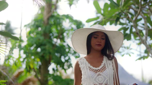 Woman In Sun Hat Walking Along On Nacpan Beach alt