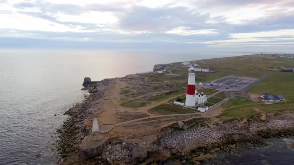 Lighthouse on the cliff aerial view at dusk in England