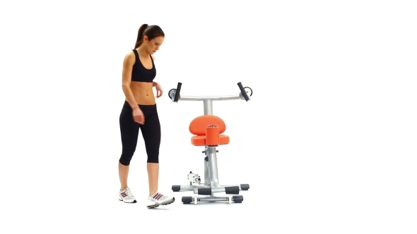 Athletic Young Woman On Hydraulic Exerciser