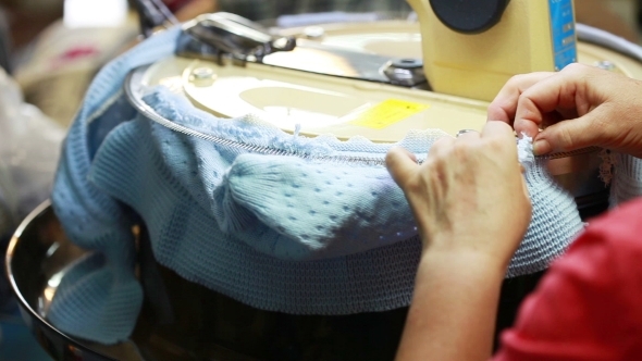 View Of Woman Running On Machine For Knitting