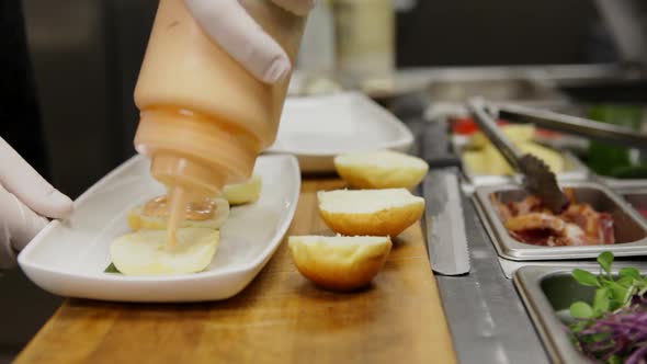 This is a Time Lapse of a chef assembling and plating 3 Slider Cheese Burgers so that they are ready alt