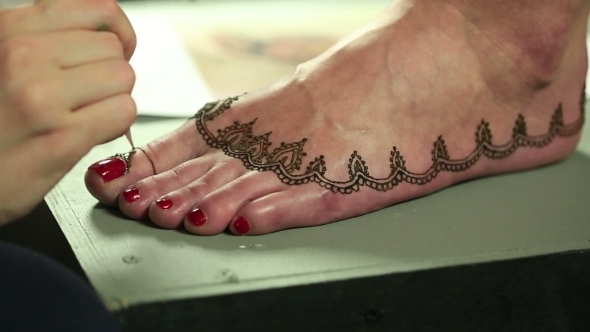 Mehndi. Master Makes Henna Pattern On Model's Foot