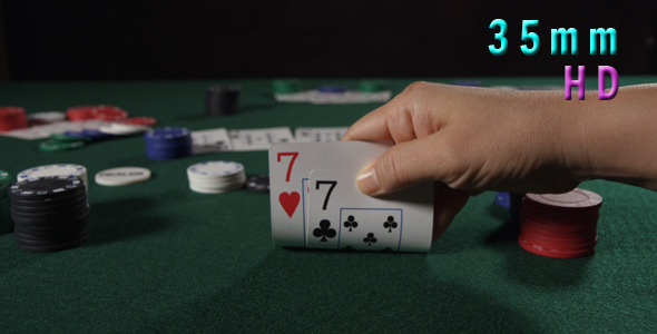 Poker Player Looks His Hand 23