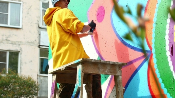 Guy Drawing With Paint From Spray On Wall
