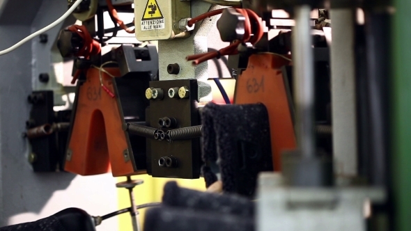 View Of Worker Fixes Boots In Machine