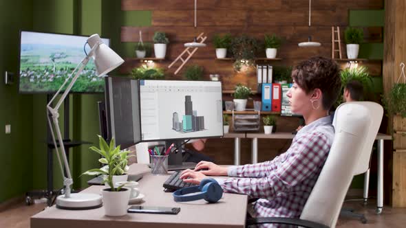 Female Designer Working on New 3D Design in Busy Creative Agency Office alt