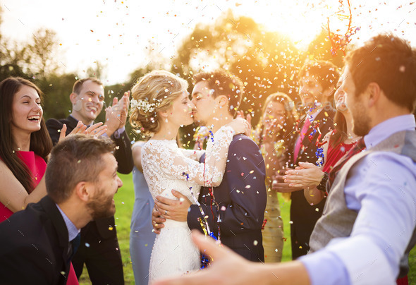 Newlyweds with guest on their garden party - Stock Photo - Images