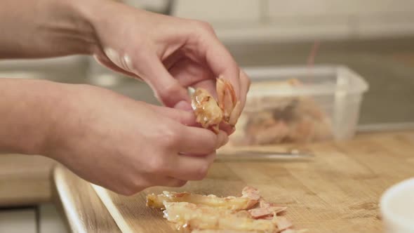 Female Hands Peeling Shrimps for Roasting alt