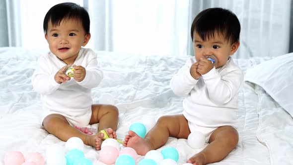 cheerful twin babies on a bed