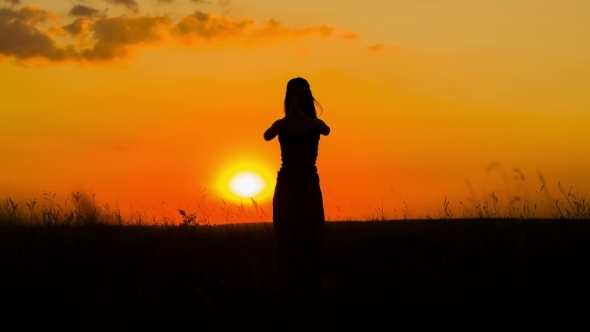 Silhouette Of a Girl Practicing Yoga  At Sunset