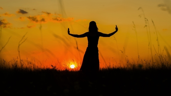 Silhouette Of a Girl Doing Yoga  At Sunset