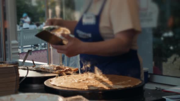 Preparation of Thin Pancakes with Fruit Bananas Gloved Hands Street Food Stove Russian alt