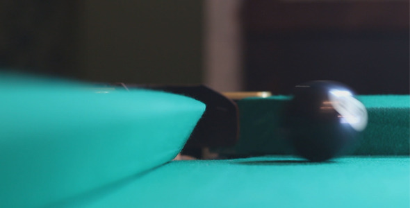 Man Rolls the Black Billiard Ball