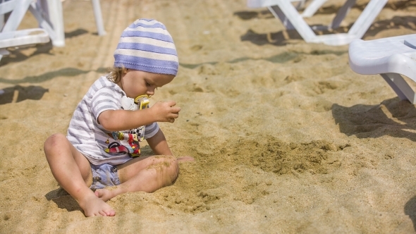 Child Playing In Sand 