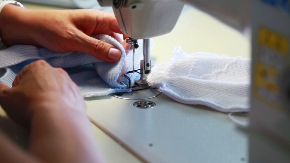 Seamstress Sews Children's Clothes On Machine