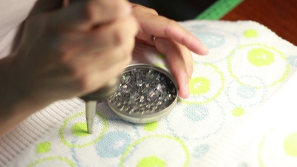 Woman Sticking Sequins On Knitted Fabric alt