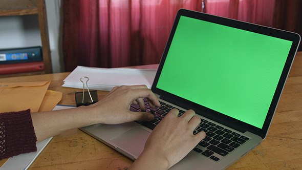 Girl Typing on Green Screen Laptop