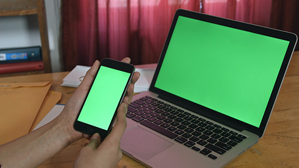 Girl Holding Phone with Laptop Green Screen