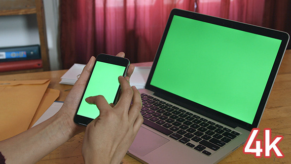Girl Using her Phone with Green Screen Laptop