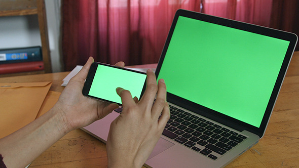 Girl Using Phone with Green Screen Laptop