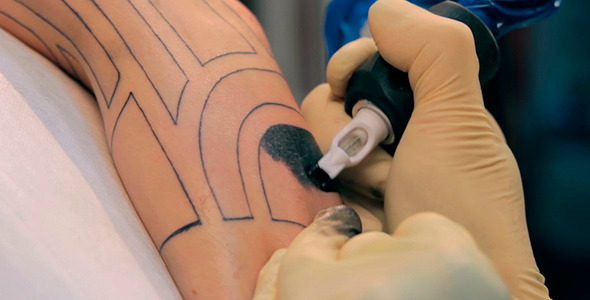 Creating A Tattoo On His Arm