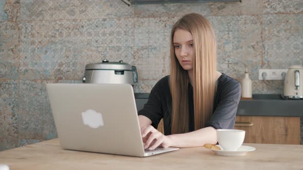 Focused Girl Using Computer for Study Online at Home. Self Isolation Concept.