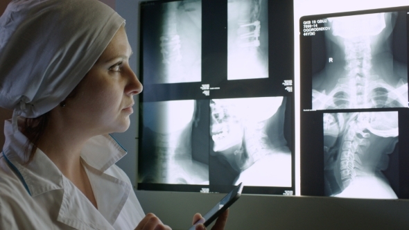 Doctor Making Notes In Tablet PC