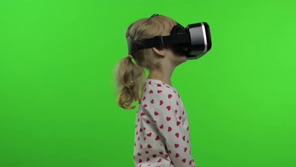Child Girl Using VR Headset Helmet To Play Game. Watching Virtual Reality 3d 360 Video. Chroma Key alt