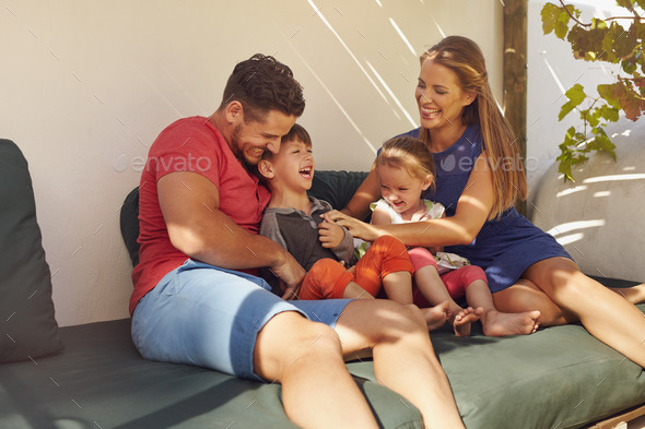 Happy young family spending time together - Stock Photo - Images