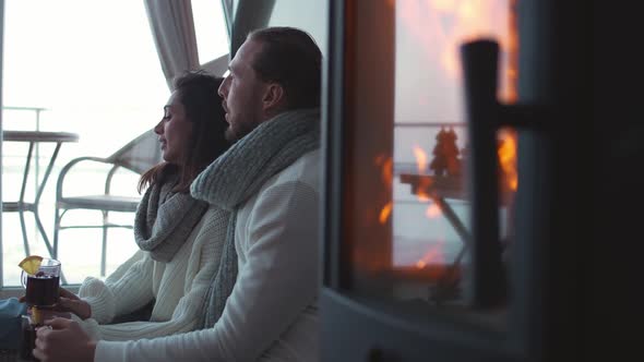 Winter Holidays a Couple of Young People Relax Lying on the Floor Near Fireplace in a Country House alt