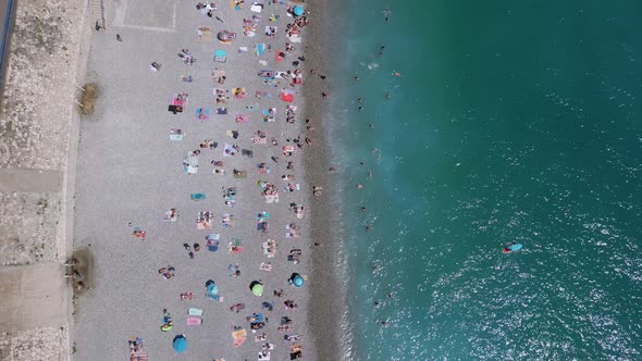 Nice beach in southern France full of people, aerial shot alt