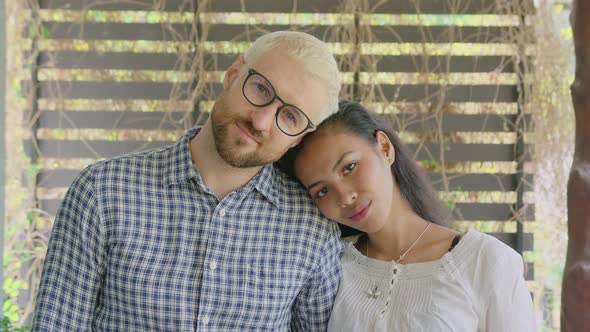 A Young International Interracial Couple in Love Looks Straight in To the Camera on a Sunny Day at alt