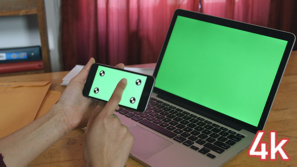 Girl Using Phone with Green Screen Laptop