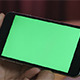 Girl Holding Smartphone with Green Screen - VideoHive Item for Sale
