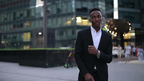 Close-up of a young black guy dancing against the backdrop of the downtown alt