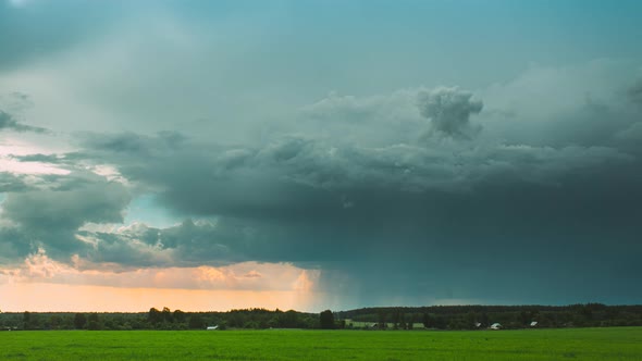 Rain Rainy Clouds Above Countryside Rural Field Landscape With Young Green Wheat Sprouts In Spring alt