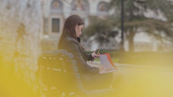 Beautiful Brunette Girl Drawing In The Album