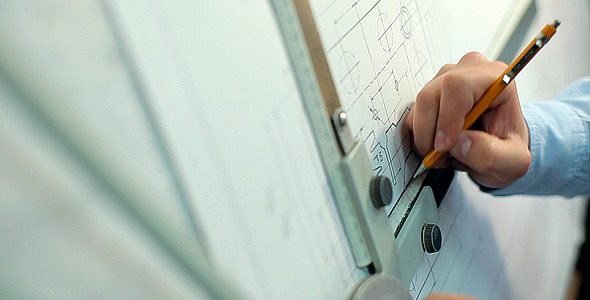 Man Draws a Technical Drawing on Drawing Board