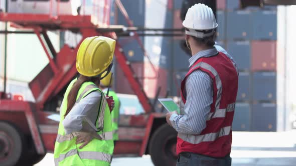 Engineer and foreman team control loading containers box from cargo, Dock worker team in a shipyard alt
