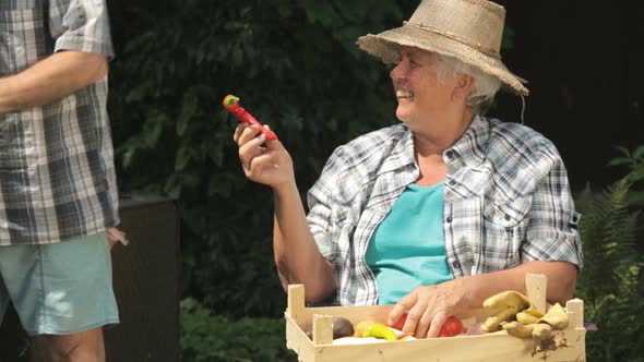 Senior Woman With Fresh Vegetables in Garden