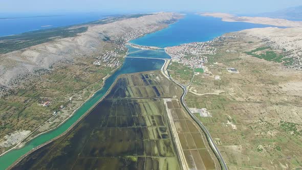 Aerial view of salt pans surrounded by sea and mountains, Pag island, Croatia alt